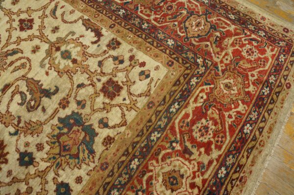 Close-up of a cream field with floral motifs and a rich red border on the persian rug by rugs on net. By rugs on net
