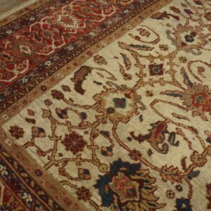 Close-up of a light field rug with intricate floral patterns and a detailed red border by Rugs On Net. by Rugs On Net