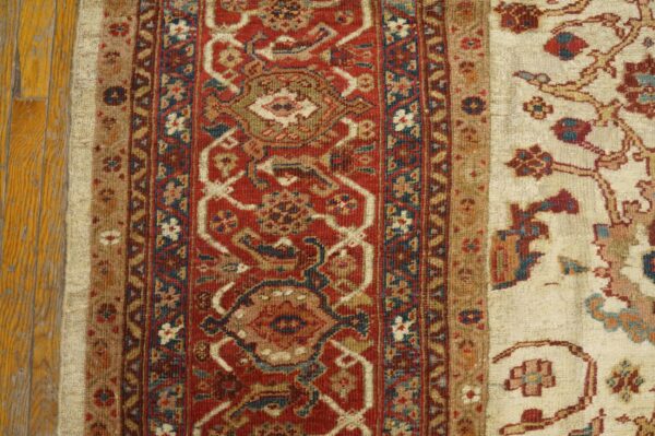 Close-up of the border detail on a traditional red and cream rug by rugs on net