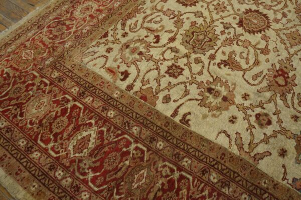 Close-up of a traditional rug featuring cream field with floral motifs and a deep red border, by rugs on net