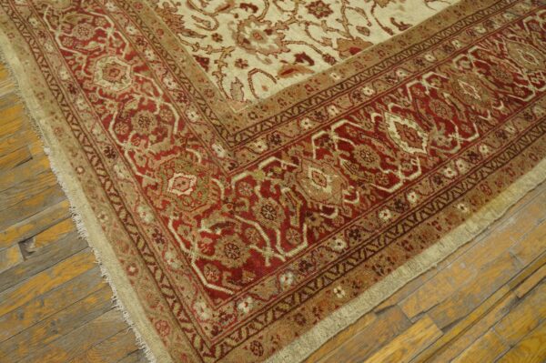 Close-up corner detail of a traditional red and beige area rug by rugs on net. By rugs on net