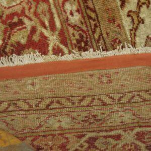 Close-up of the fringe and backing of a traditional red and beige rug by Rugs On Net. by Rugs On Net