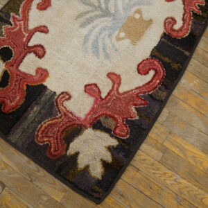 Close-up of a hooked rug with red scrollwork on a cream field, by Rugs On Net