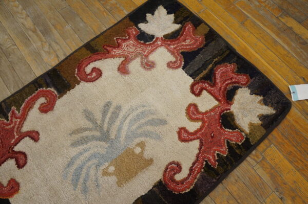 Close-up of a colorful hooked rug with red scrollwork on a cream field, by rugs on net