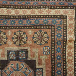 Close-up of the corner design of the Tribal Rug, featuring terracotta, blue, and cream geometric patterns by Rugs On Net
