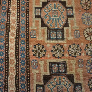 Close-up of a geometric patterned rug with earthy tones and blue accents by Rugs On Net. by Rugs On Net