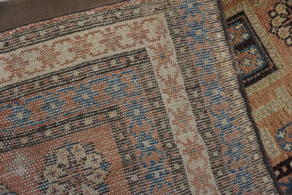 Close-up of a woven kilim with geometric patterns in rust, blue, and beige by rugs on net