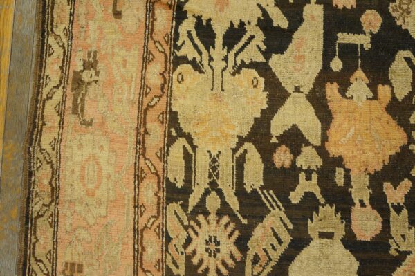 Close-up detail of a tribal rug border with geometric shapes in muted pink, beige, and dark brown, by rugs on net