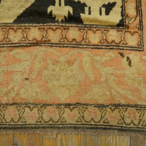 Close-up of the border detail on a vintage rug featuring salmon and beige tones by Rugs On Net