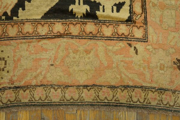 Close-up of the border detail on a vintage rug featuring salmon and beige tones by rugs on net