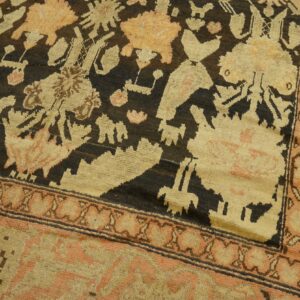 Close-up of a tribal rug with dark field and geometric motifs in cream and peach tones by Rugs On Net