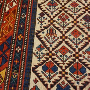 Close-up of geometric patterns and rich colors on the Caucasian Rug by Rugs On Net. by Rugs On Net