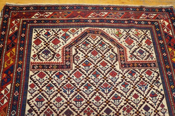 Close-up of a prayer niche design on the caucasian rug by rugs on net