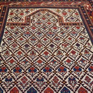 Close-up of a tribal rug with geometric motifs in red, blue, and cream, by Rugs On Net. by Rugs On Net