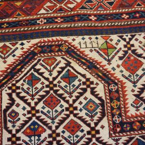 Close-up of geometric medallions and borders on a Caucasian rug by Rugs On Net