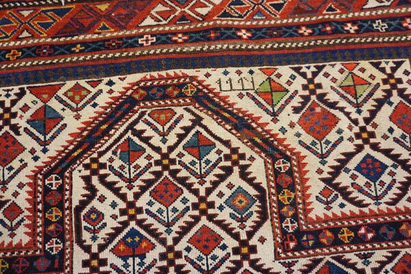 Close-up of geometric medallions and borders on a caucasian rug by rugs on net