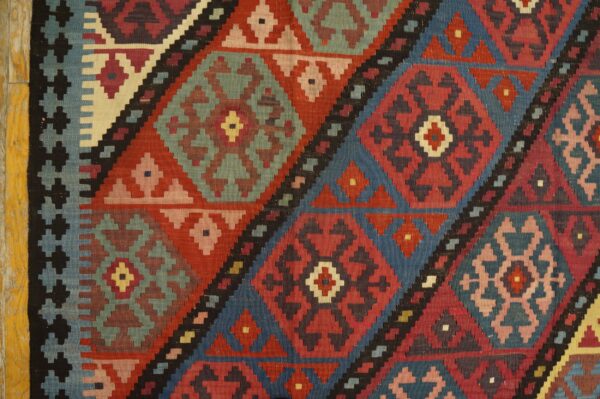 Close-up of geometric diamond patterns in a colorful kilim rug by rugs on net