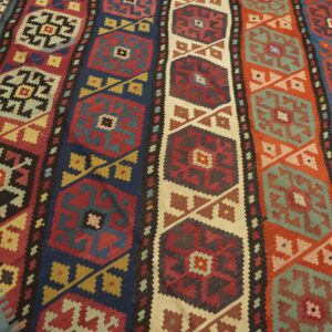 Close-up of a colorful striped kilim rug with geometric medallions by Rugs On Net
