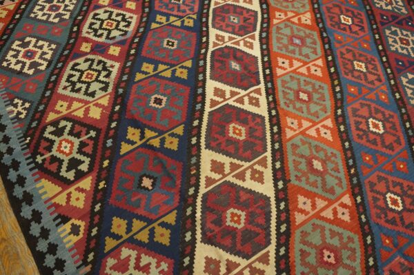 Close-up of a colorful striped kilim rug with geometric medallions by rugs on net