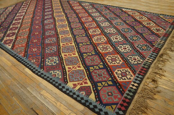 Colorful striped kilim rug with geometric medallions on a wooden floor by rugs on net