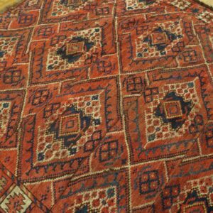 Close-up of a richly patterned, antique red and navy geometric rug by Rugs On Net. by Rugs On Net