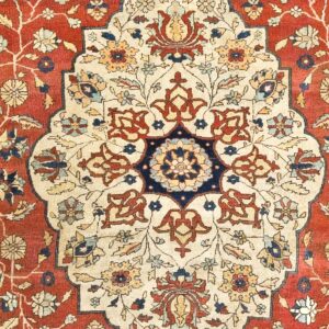 Close-up of a medallion detail on a red and cream antique Persian rug by Rugs On Net
