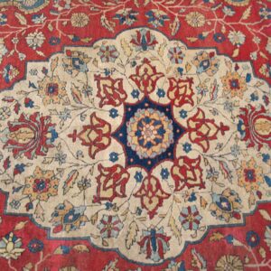 Close-up of a traditional Persian rug design featuring a cream medallion on a red field by Rugs On Net. by Rugs On Net