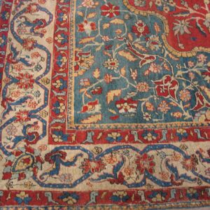 Close-up of a detailed Persian rug border with red, blue, and beige elements by Rugs On Net