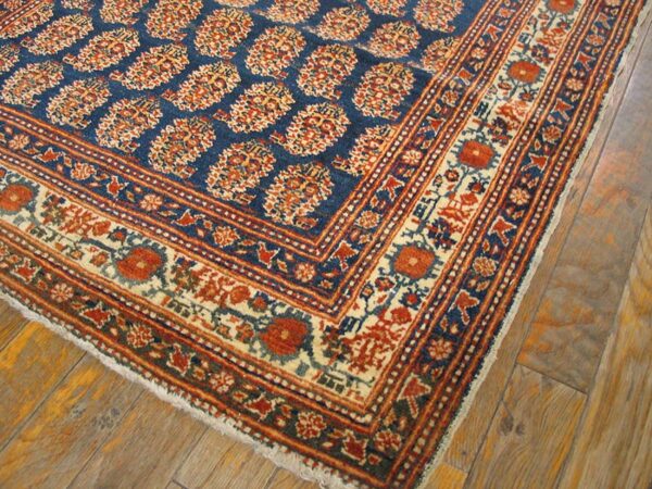 Close-up of a blue and red patterned rug corner by rugs on net
