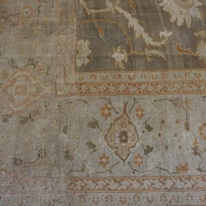 Close-up of a distressed, neutral-toned Persian rug border with subtle floral motifs by Rugs On Net