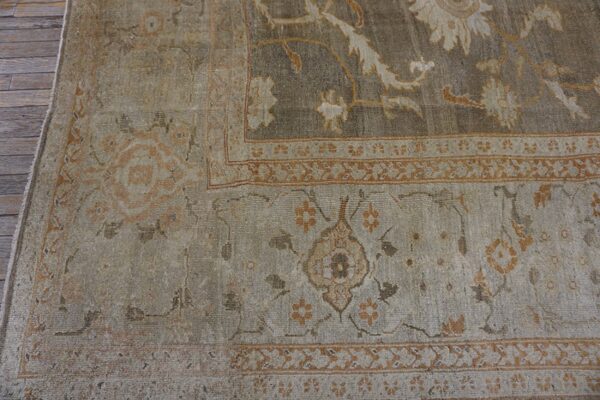 Close-up of a distressed, neutral-toned persian rug border with subtle floral motifs by rugs on net