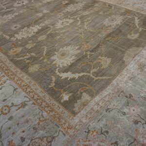 Close-up view of a distressed gray and beige floral pattern rug by Rugs On Net. by Rugs On Net