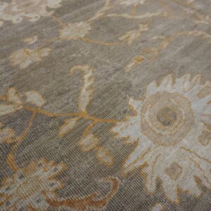 Close-up texture shot of a muted gray and gold floral pattern on a rug by Rugs On Net. by Rugs On Net