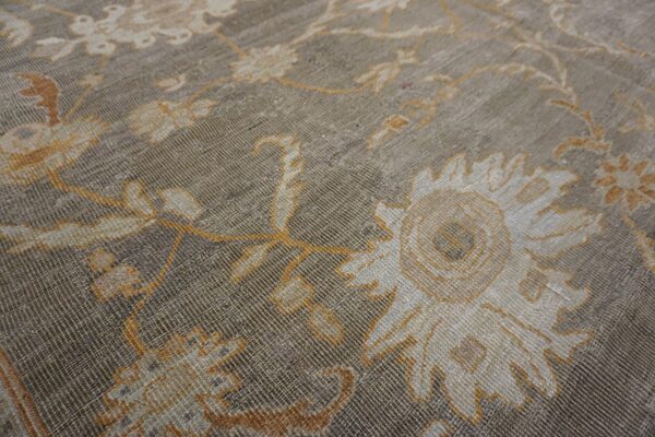 Close-up texture shot of a muted gray and gold floral pattern on a rug by rugs on net. By rugs on net
