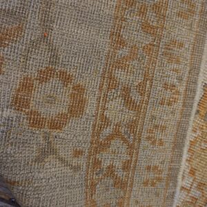 Close-up texture of a beige and brown patterned rug by Rugs On Net