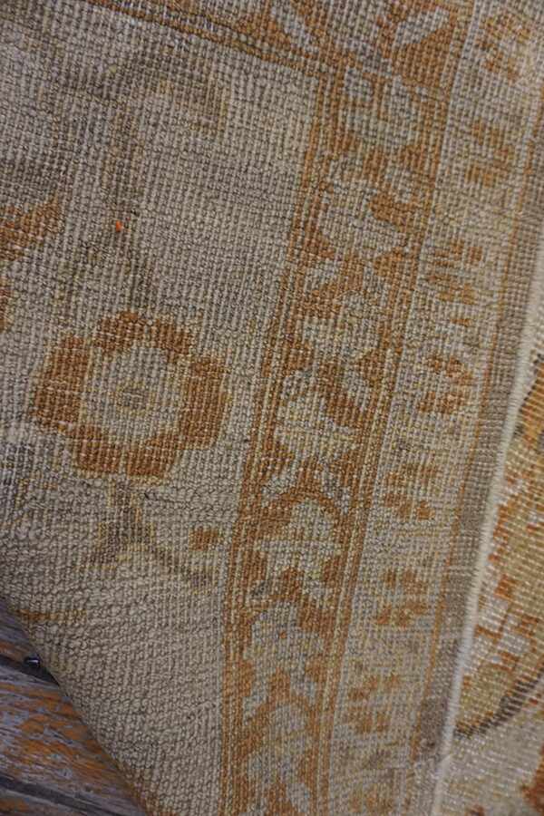 Close-up texture of a beige and brown patterned rug by rugs on net