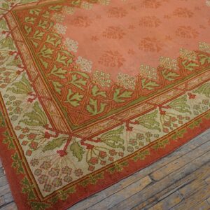 Close-up of the corner of a salmon and green patterned rug by Rugs On Net