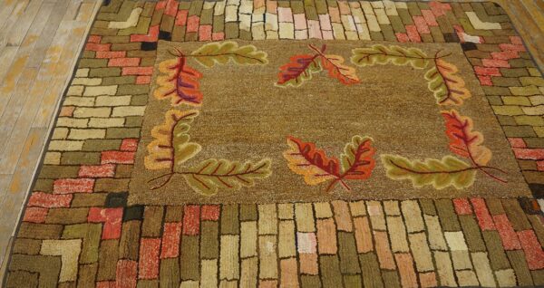 A hooked rug featuring a central field with autumn oak leaves and a brick-patterned border, by rugs on net. By rugs on net