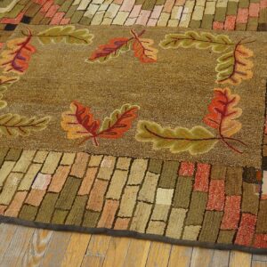 Close-up of a hooked rug featuring an autumnal oak leaf border design on a brown field, by Rugs On Net