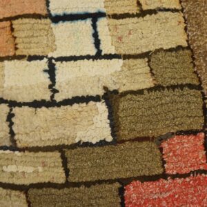 Close-up of a textured, patchwork-style rug with earthy tones and black outlines by Rugs On Net