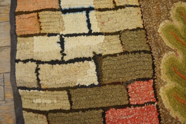 Close-up of a textured, patchwork-style rug with earthy tones and black outlines by rugs on net