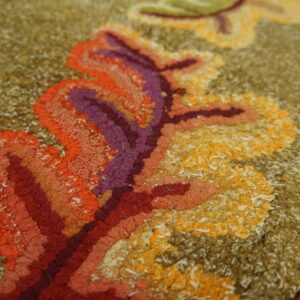 Close-up of rich, textured loops in red, orange, purple, and yellow on a brown background of the Autumn Leaves Rug by Rugs On Net. by Rugs On Net