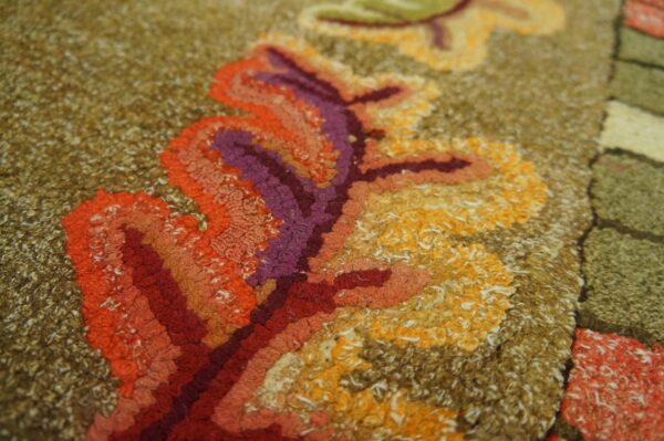 Close-up of rich, textured loops in red, orange, purple, and yellow on a brown background of the autumn leaves rug by rugs on net. By rugs on net