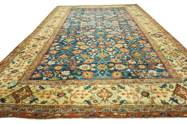 Close-up view of a deep blue and orange floral rug by rugs on net. By rugs on net