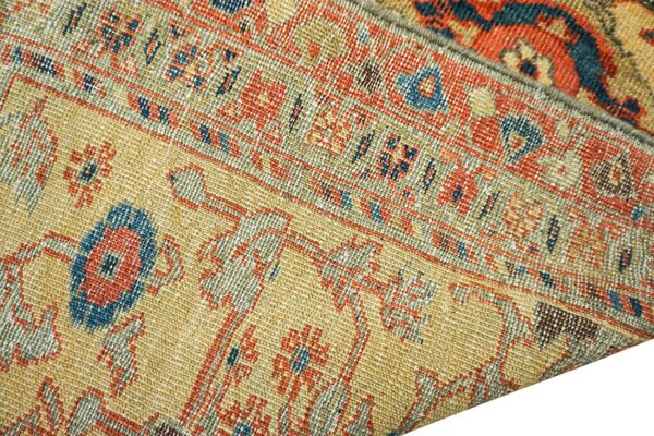 Close-up texture of an antique rug with geometric patterns in gold, red, and blue by rugs on net