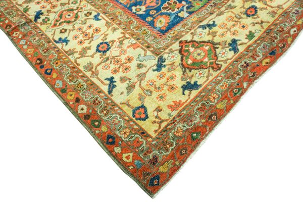 Corner detail of a cream and rust oriental rug with blue accents by rugs on net. By rugs on net