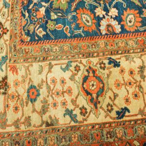 Close-up of a traditional rug with cream, blue, and orange motifs by Rugs On Net