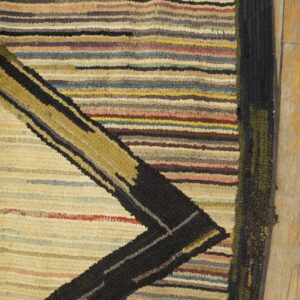Close-up of a multicolored striped rug with a black and gold geometric design, by Rugs On Net. by Rugs On Net