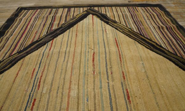 Close-up of a striped rag rug with a central beige area framed by multicolored vertical stripes, by rugs on net