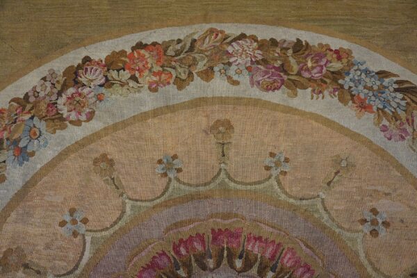 Close-up of a floral tapestry border featuring pink, blue, and white blossoms against muted tones, by rugs on net